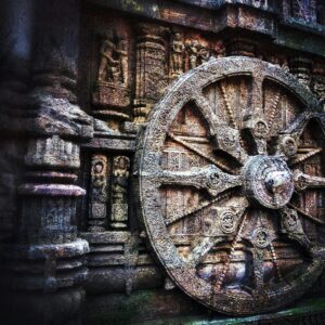 Intricate stone carving of a chariot wheel at the historic Konark Sun Temple, India.
